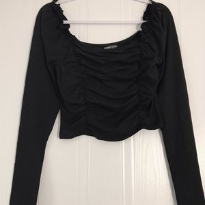 Black top with frills and sweetheart neckline